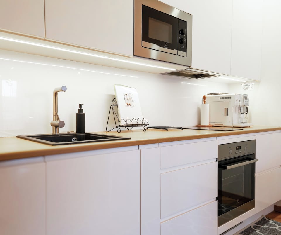 Sleek kitchen: ample counter space, dishwasher, drying rack + supplies.