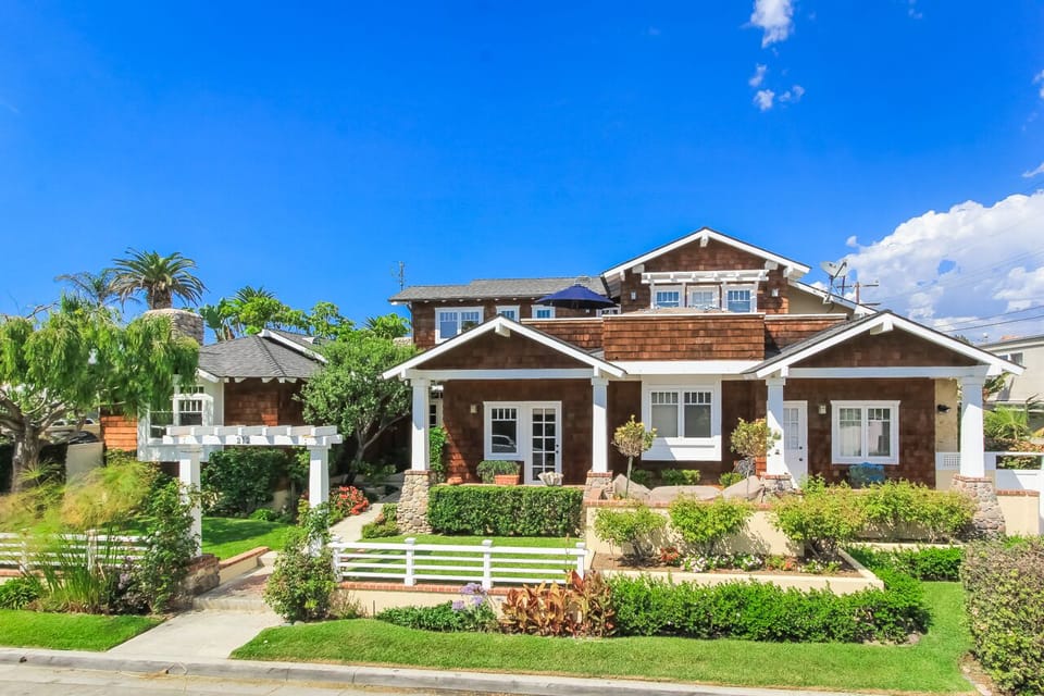 The beautiful Craftsman style home is located 150 yards from the sand.
