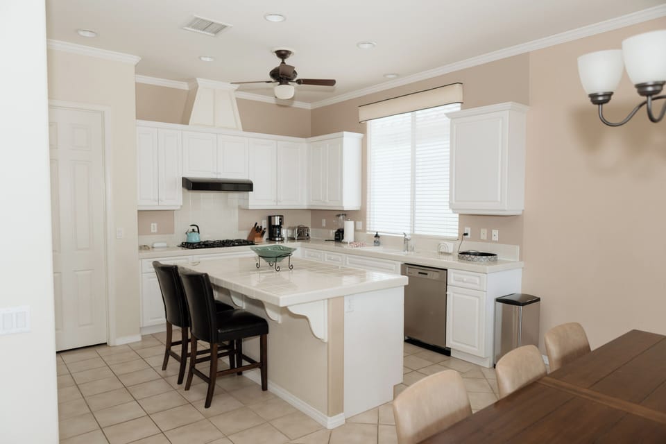 Kitchen angle showing island seating & open layout