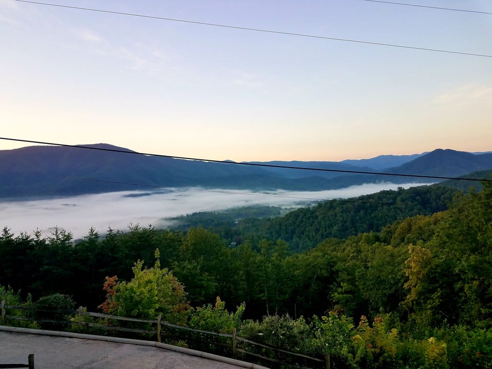 This is the stunning summer morning view when fog seeps over the valley.