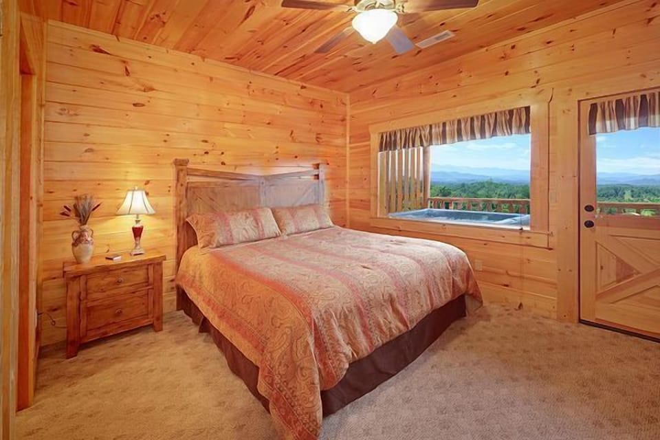 Second bedroom on lower level with door to back deck and hot tub
