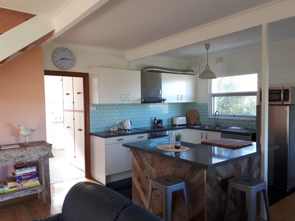 Open plan kitchen with high-quality Smeg appliances.