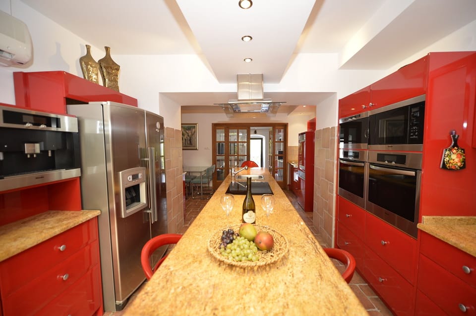This Kitchen with a Miele Coffee/Espresso Maker, Full-size Fridge 