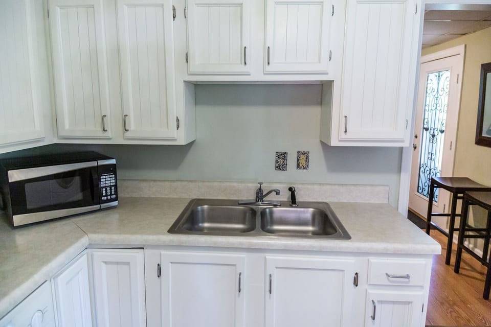 Cabinets are stocked with oils, vinegars, spices & cooking basics. 