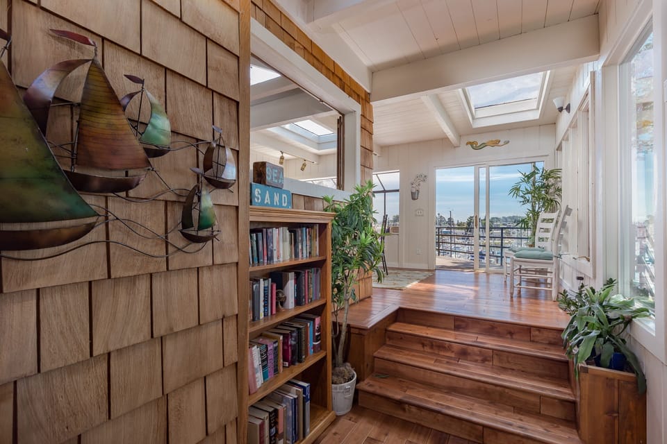 entryway with skylights, steps to sunroom with harbor views