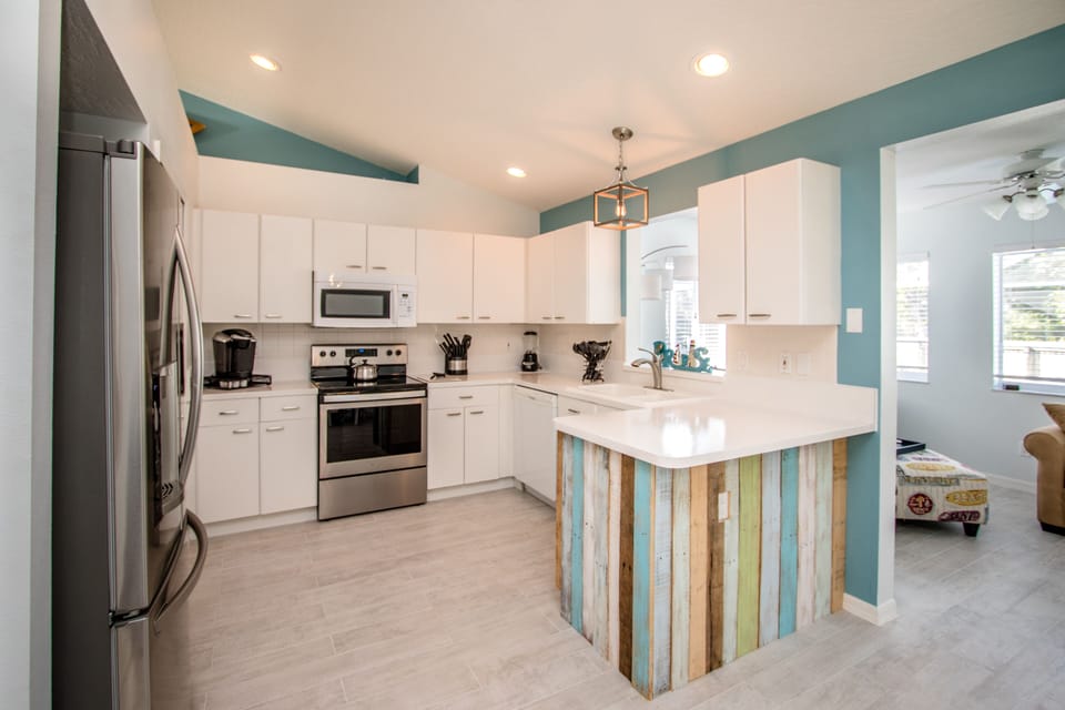 Airy and Light Kitchen with pass though window and bar top