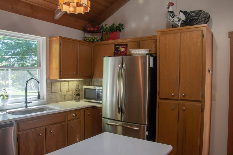 The roomy kitchen is open to the dining area for great gatherings while you prepare and share meals.
