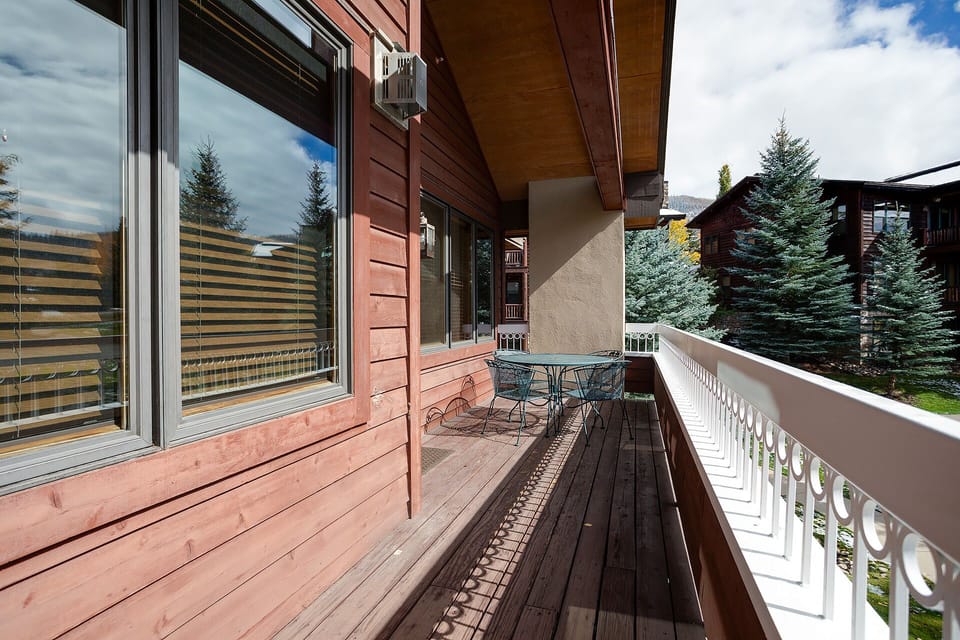 Step onto your private balcony and breathe in the mountain air while enjoying morning coffee at your outdoor dining table.