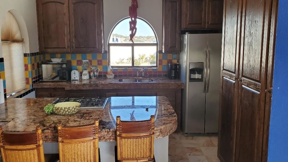 Kitchen faces entry courtyard north and beach facing south. Ocean view