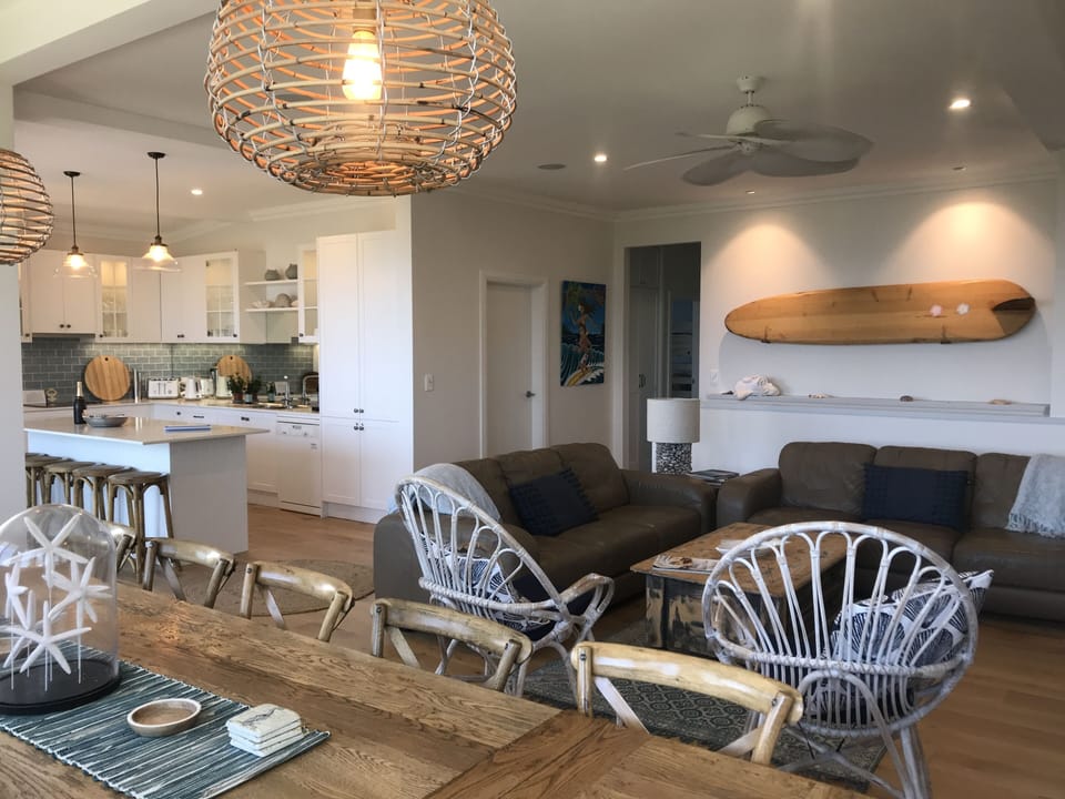 Open plan living, dining & kitchen on the mid level. Features fireplace and view