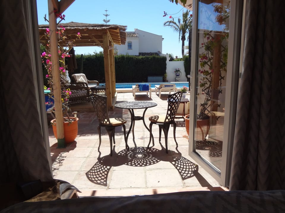 View of Pool Area from Master Bedroom French Window