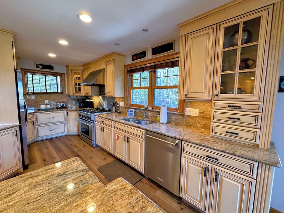 The chef's kitchen, complete with high-end appliances and a separate wine bar, makes entertaining effortless, while the spacious dining area provides the perfect setting for unforgettable gatherings