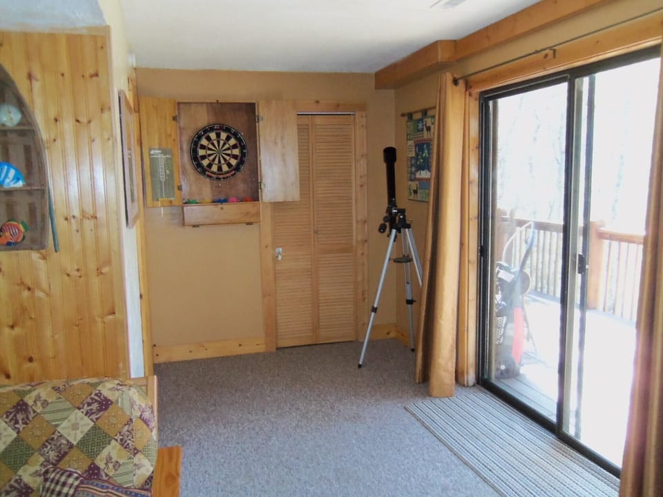 Game room, darts and deck that goes down to fenced in yard.