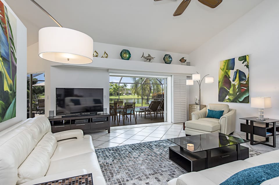 Private lakefront view inside modern but cozy living room 65" 4K TV real leather