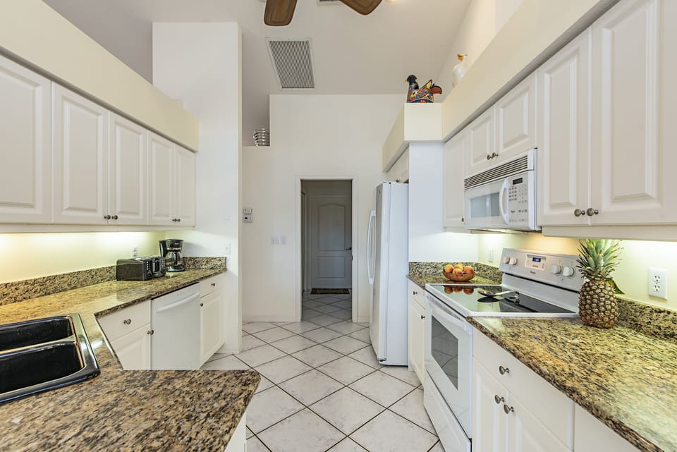 Kitchen with adjacent utility storage and laundry room 