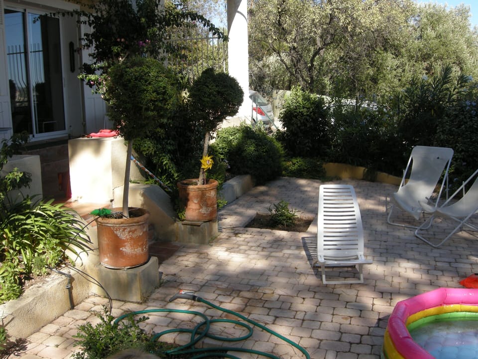 Small garden and its watering hose