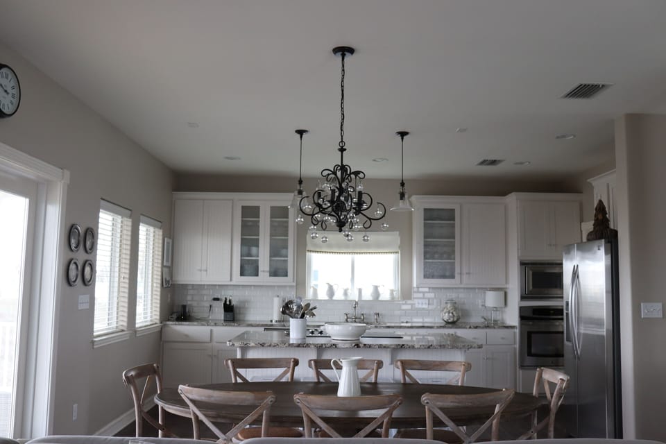 Fully equipped kitchen with tons of seating and exit to huge porch. 