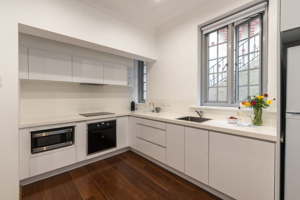 Fully Equipped Designer Kitchen with Stone Benchtops and integrated dishwasher