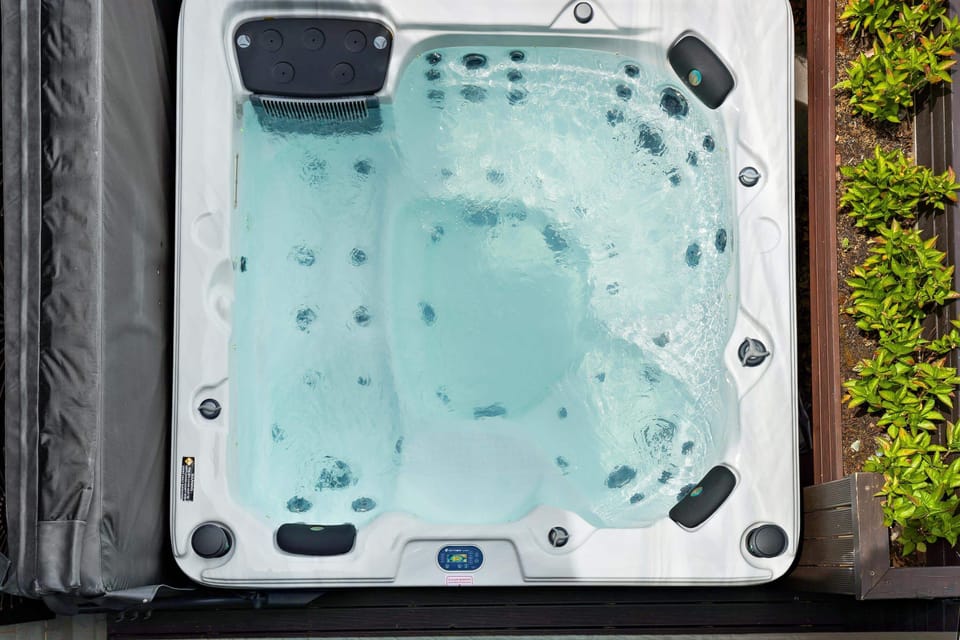 Spa Retreat: Indulge in relaxation in your private hot tub surrounded by lush greenery! Luxury private spa.