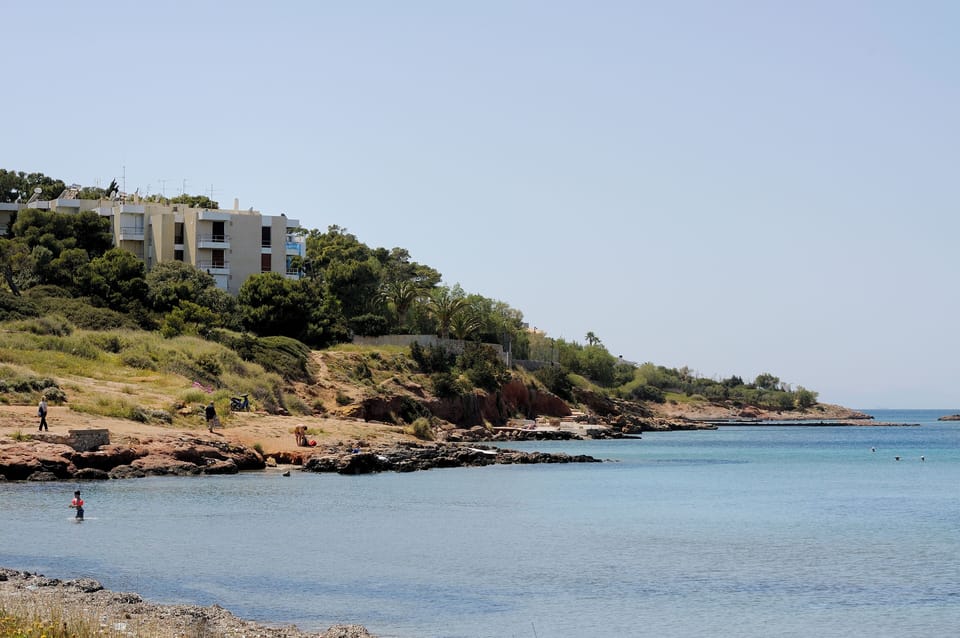 Block of flats as seen from nearby small sandy beach and restaurant
