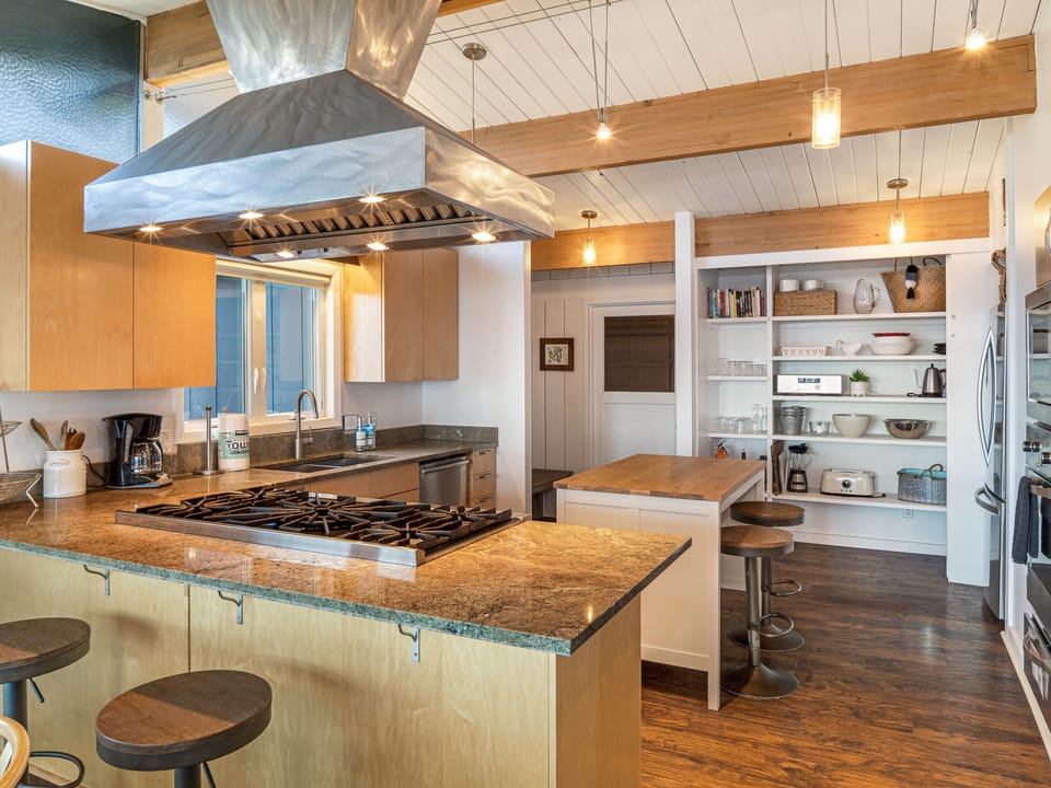 Fully stocked, open, and modern kitchen with Viking Professional appliances and All-Clad cookware.