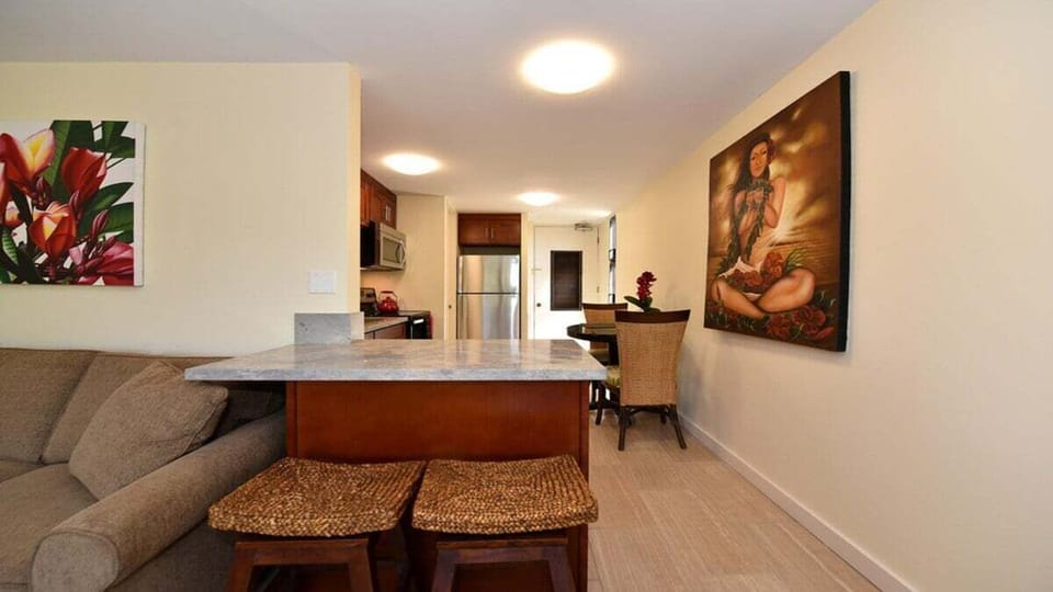 Functional breakfast bar with woven stools and a view into the modern kitchen for convenient dining