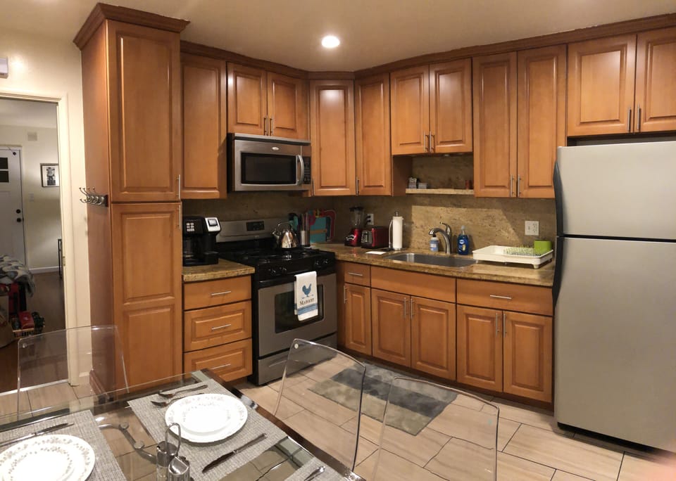 Fully stocked kitchen with stove, Microwave, mixer, toaster, tea pot. 