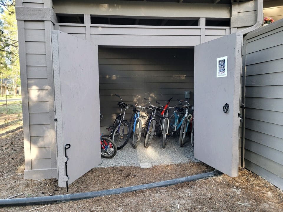 12 adult bikes, 2 junior bikes and a tricycle locker