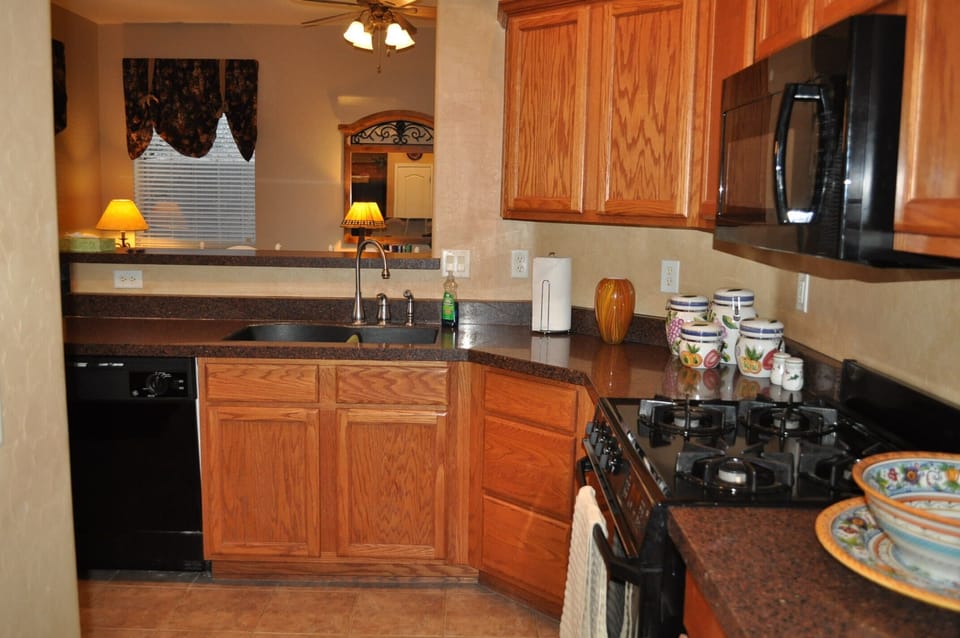 Gourmet Kitchen w/ granite, gas range, microwave, dishwasher and breakfast bar