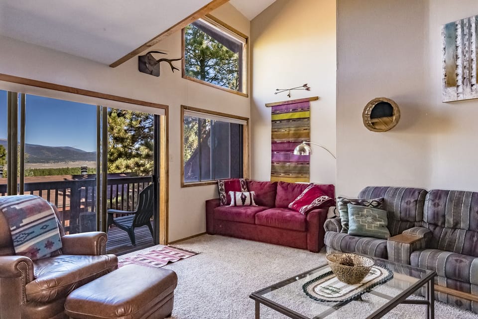 A comfortable  living room with access to the patio overlooking the mountains!