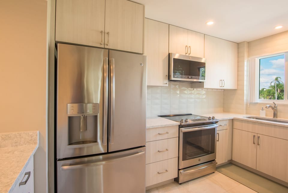 Stainless appliances and unique tile backsplash.
