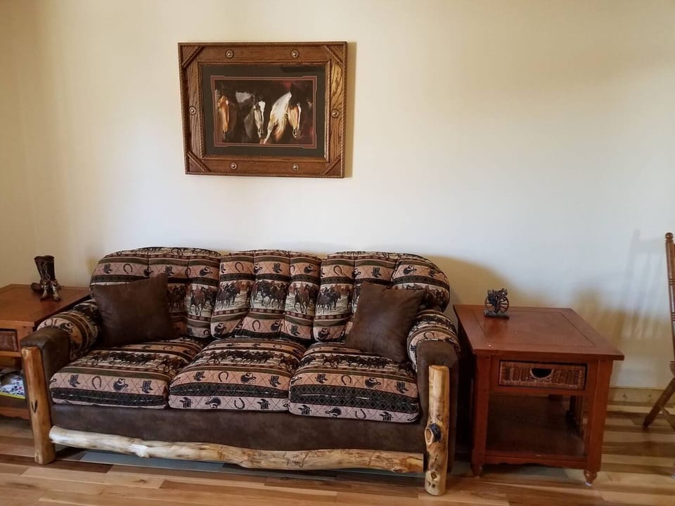 The living room sports a fun western motif and is complete with a couch, chair and a smart TV. High speed Wi-Fi is also included.