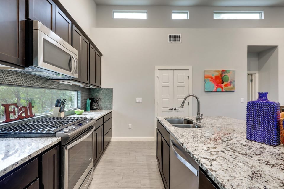 The kitchen has stainless steel appliances and granite countertops
