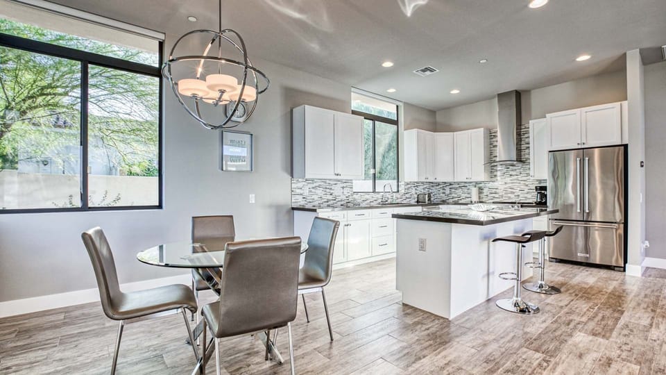 Bright kitchen with stainless appliances, island seating, and chic design