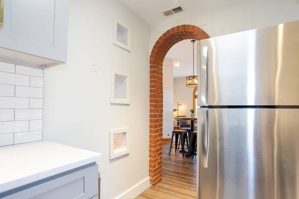 The open layout allows whoever is in the kitchen to have a conversation with the people sitting at the dining table.