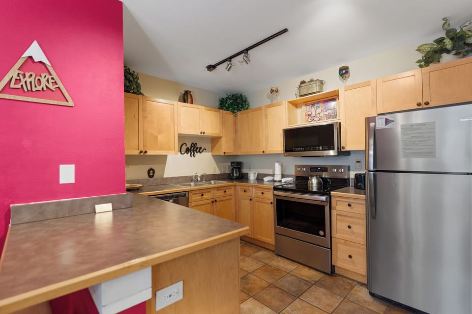The full kitchen features stainless steel appliances.