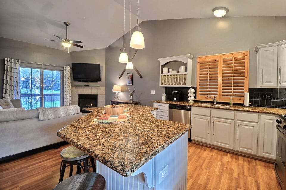 Another View of the Gourmet Kitchen with Fireplace and Deck in the Background