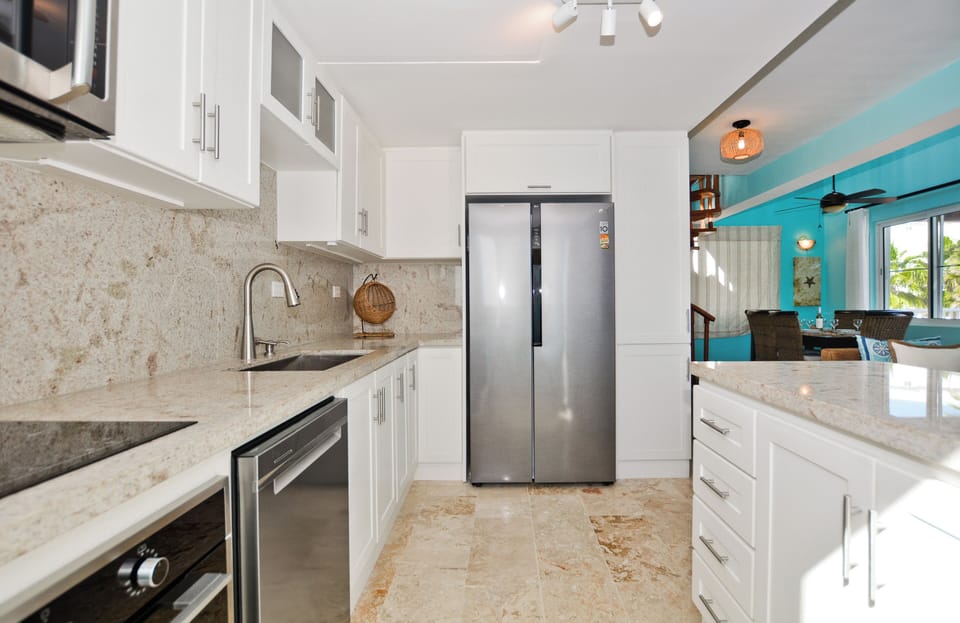Modern appliances include stainless steel refrigerator and dishwasher