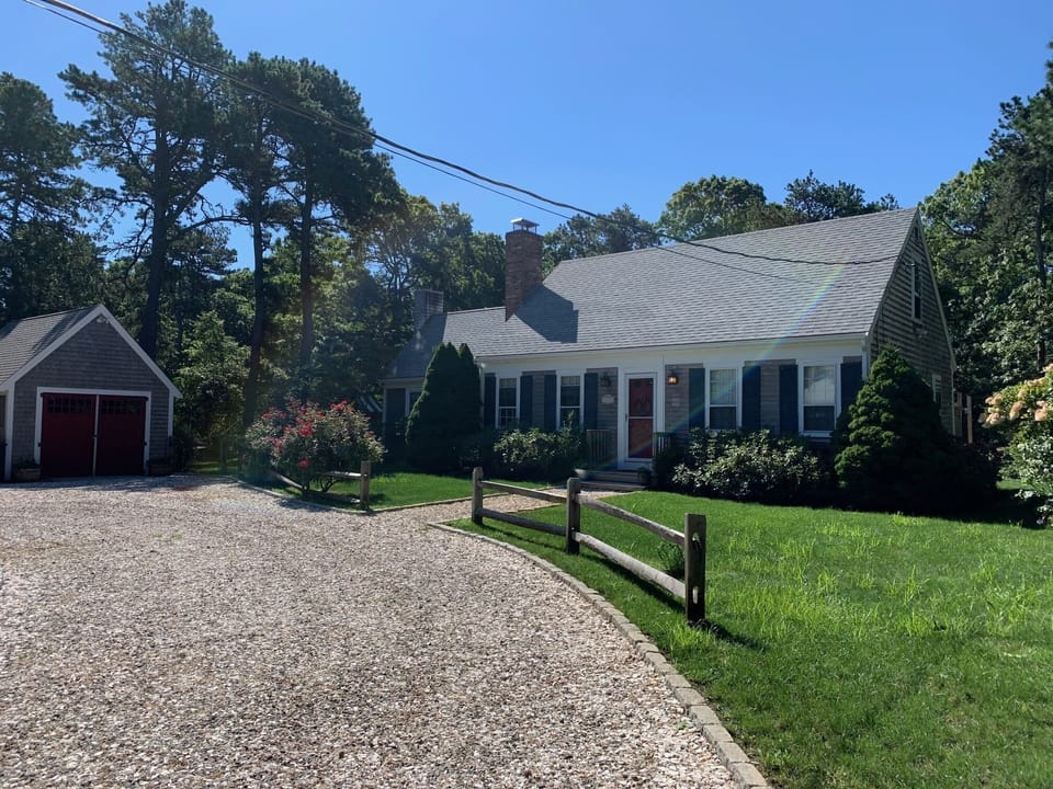 Front view, large driveway with plenty of parking.