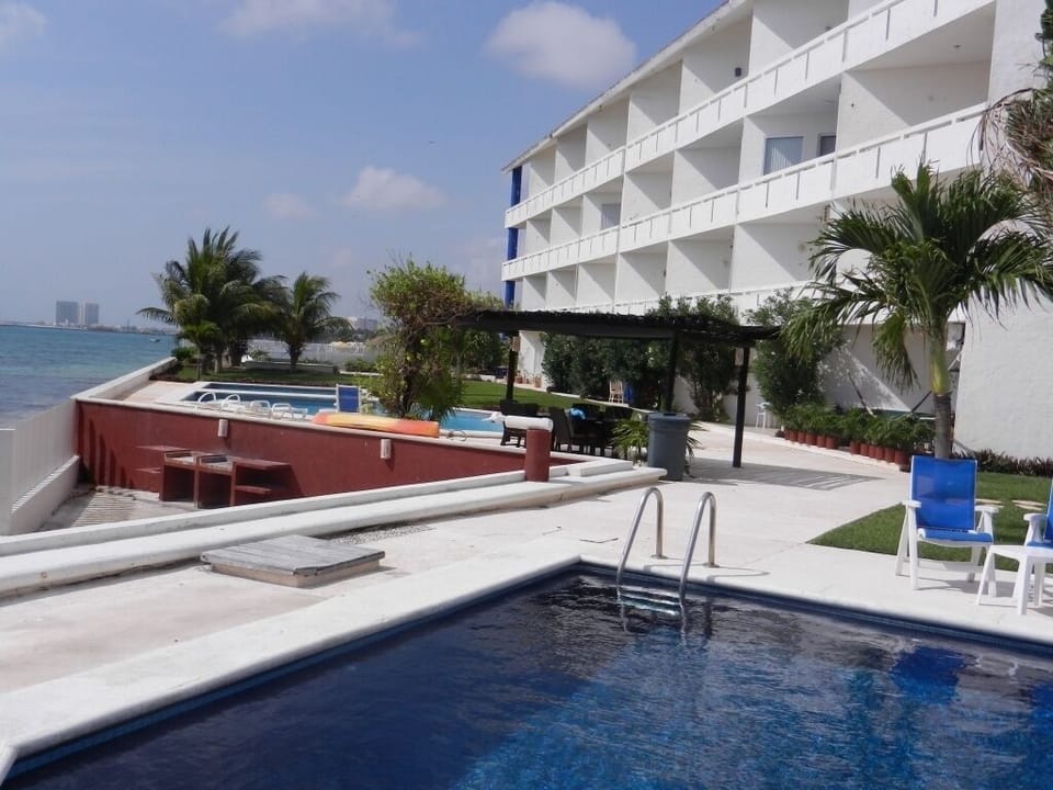 common areas. 4 pools. 2 palapa areas. Stairs leading to BBQ and stairs to sea.
