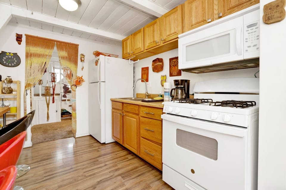 Fully equipped cabin kitchen with ample cabinetry, stove, fridge, microwave, and coffee maker—perfect for cooking meals, morning coffee, and feeling right at home on your stay.