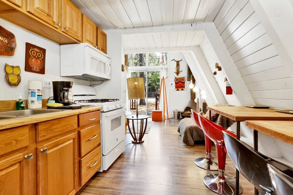 Fully equipped cabin kitchen with ample cabinetry, stove, fridge, microwave, and coffee maker—perfect for cooking meals, morning coffee, and feeling right at home on your stay.
