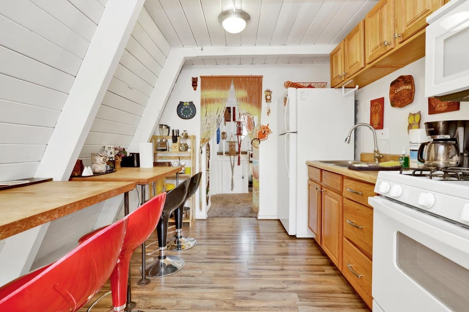Fully equipped cabin kitchen with ample cabinetry, stove, fridge, microwave, and coffee maker—perfect for cooking meals, morning coffee, and feeling right at home on your stay.