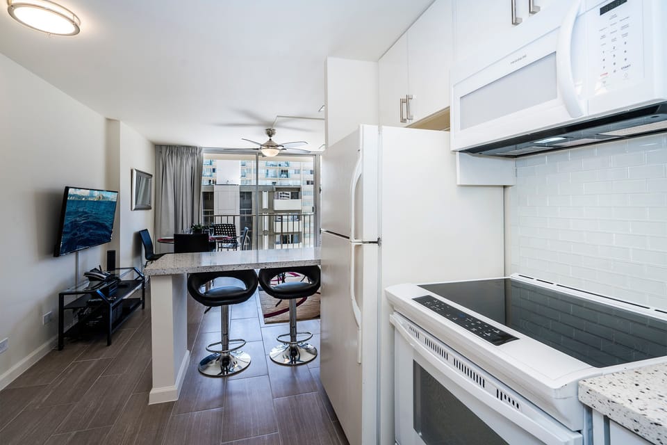 Full Kitchen with Counter Space and Bar Chairs for 2