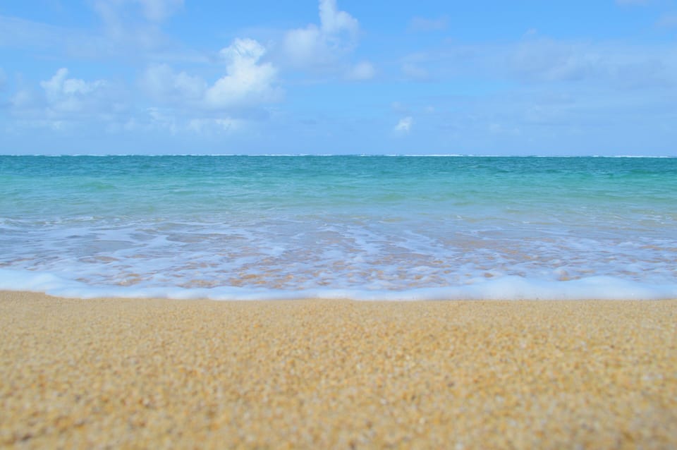 Sandy beach and calm ocean at this location.