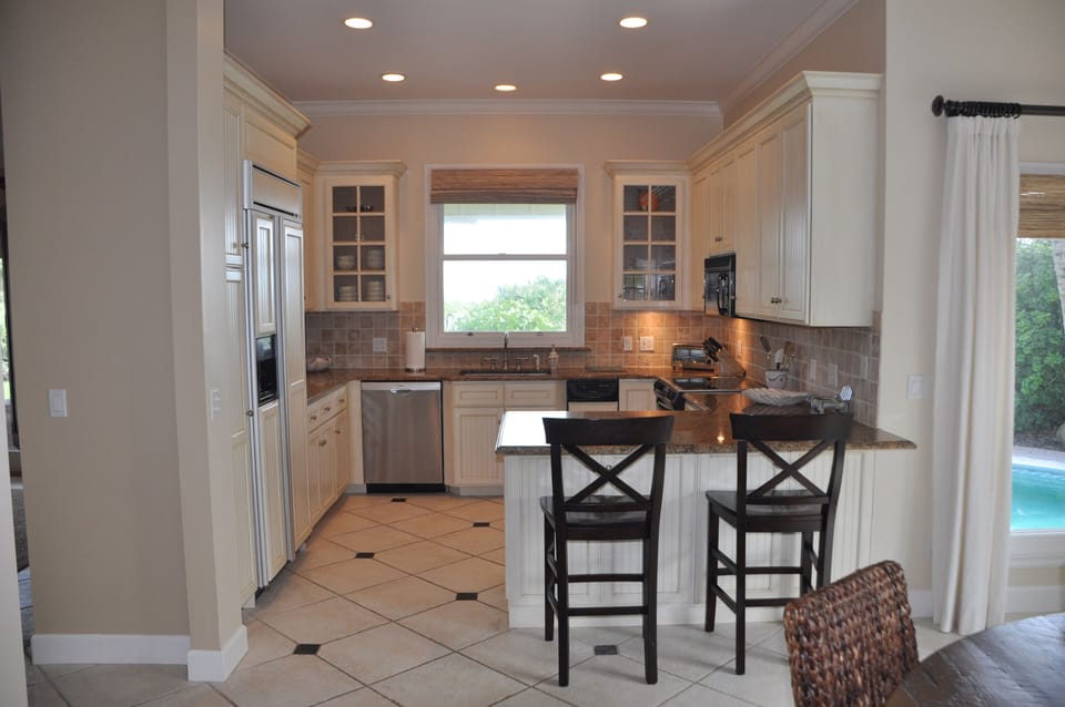 Gourmet kitchen with bead-board cabinets, stainless appliances and granite.