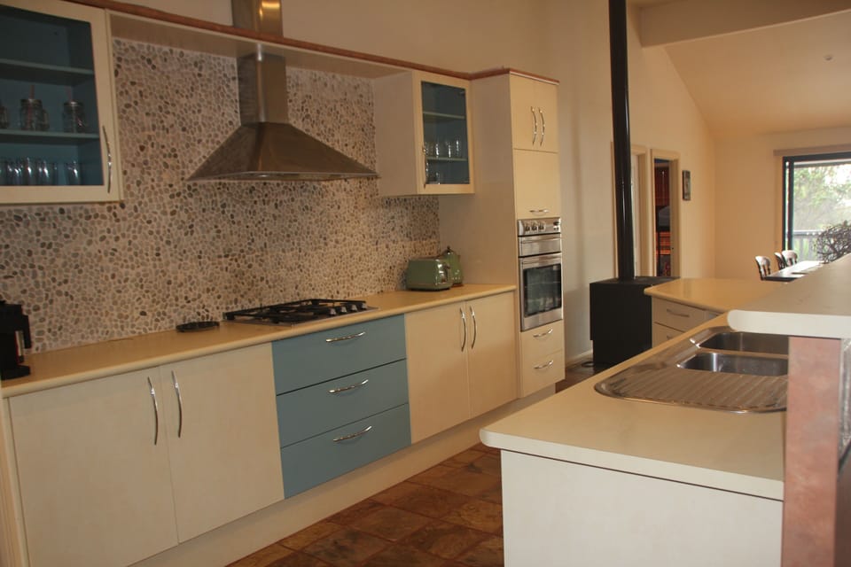 Kitchen with large fridge and walk in pantry and all the utensils you'll need!