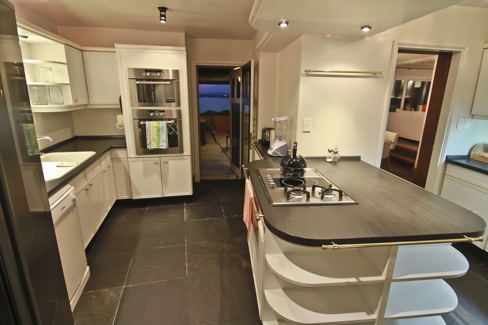 Kitchen is adjacent to the outdoor bar-b-que & terrace and indoor dining.