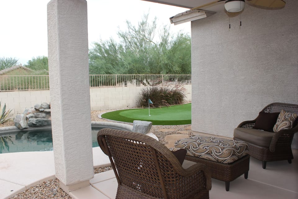 Covered patio area with ceiling fan