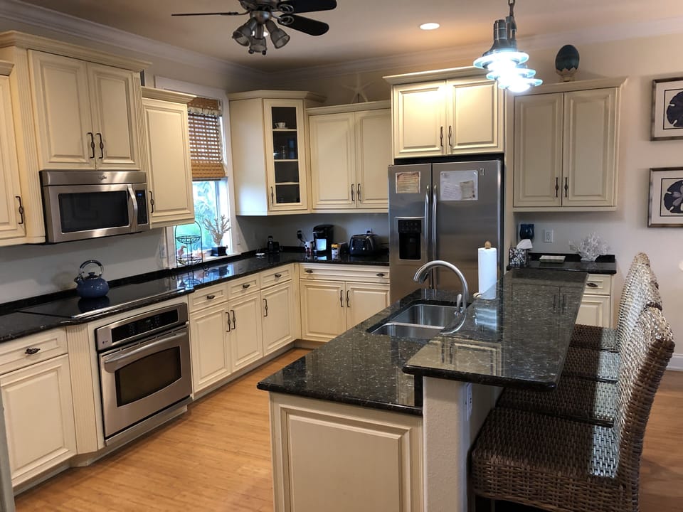 New G E Profile appliances in kitchen with breakfast bar.
